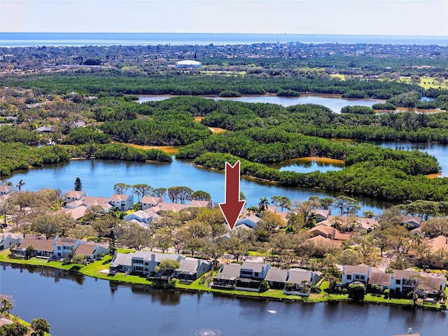 birds eye view of property with a residential view, a water view, and a forest view