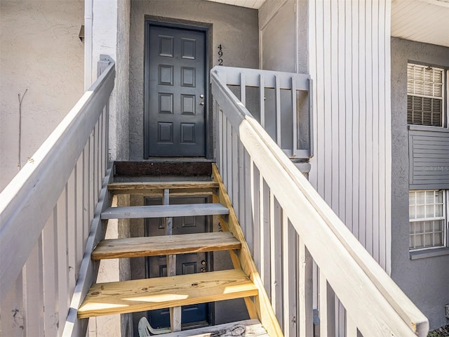 doorway to property with stucco siding