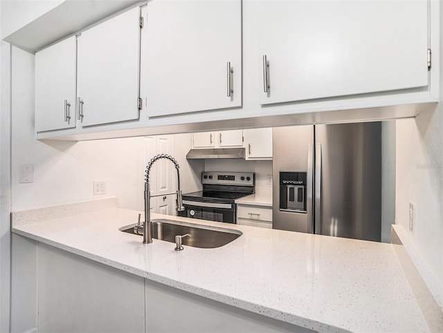 kitchen with a sink, white cabinets, under cabinet range hood, and stainless steel appliances