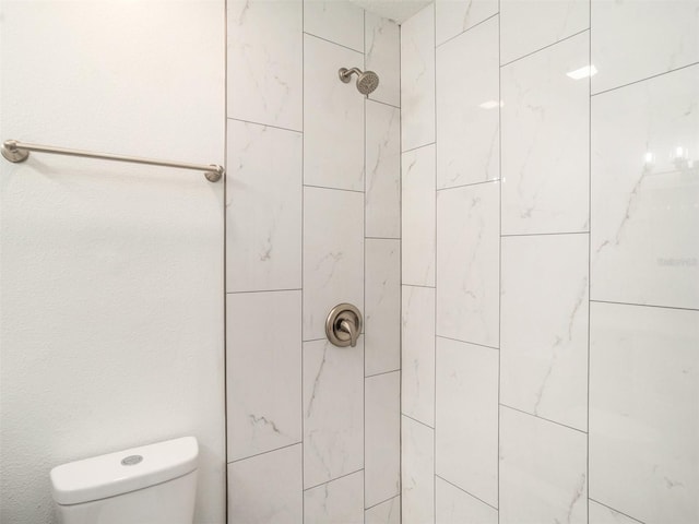 full bathroom with toilet and tiled shower