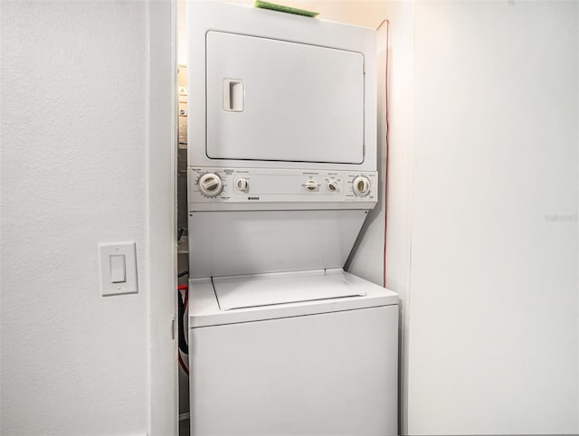 laundry room featuring laundry area and stacked washer / drying machine