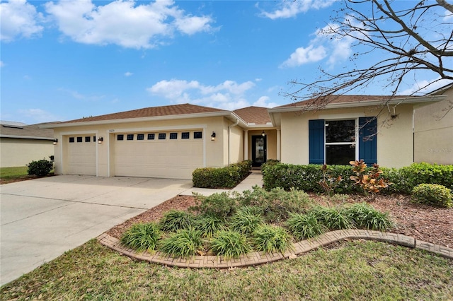 ranch-style home featuring a garage, driveway, and stucco siding