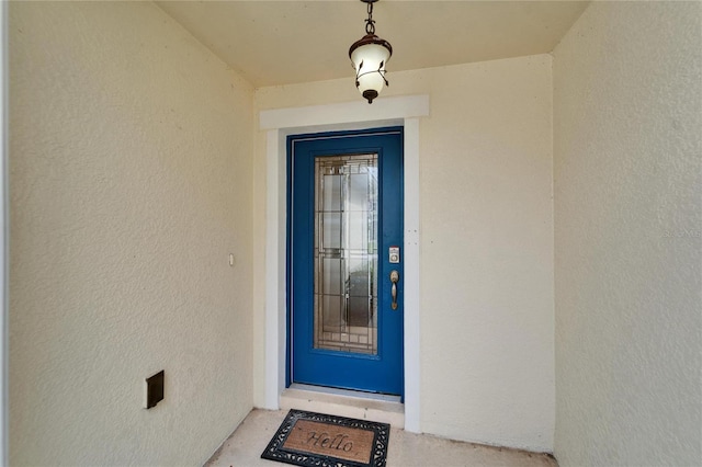 property entrance featuring stucco siding