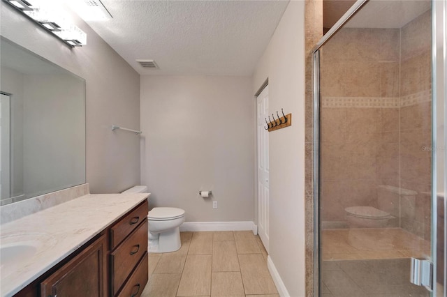 bathroom with visible vents, a textured ceiling, vanity, and toilet