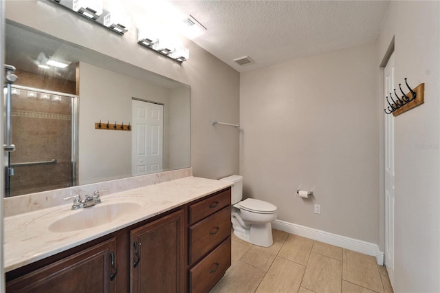 bathroom with toilet, a textured ceiling, vanity, a shower stall, and a closet