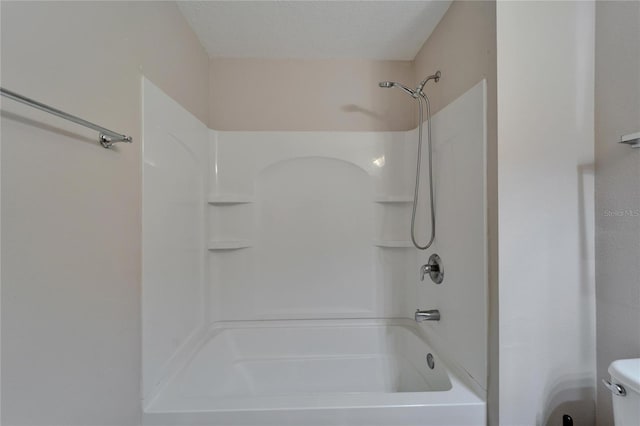 full bath with a textured ceiling, shower / tub combination, and toilet