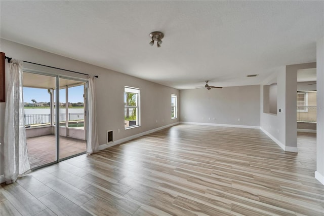 spare room featuring a wealth of natural light, light wood-type flooring, and visible vents