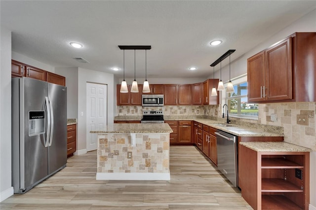 kitchen featuring hanging light fixtures, appliances with stainless steel finishes, a sink, and visible vents