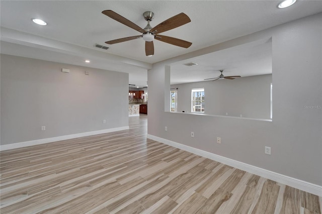 empty room with light wood-type flooring, visible vents, baseboards, and recessed lighting