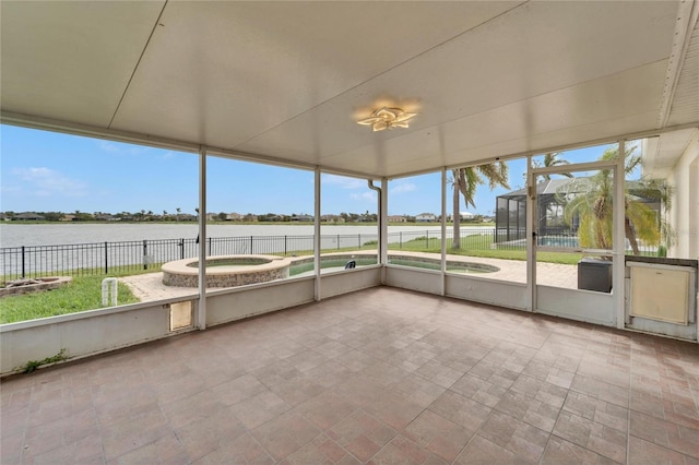 unfurnished sunroom featuring a water view