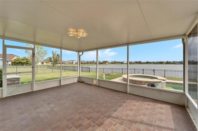 unfurnished sunroom featuring a water view