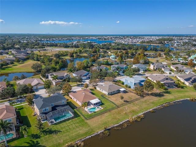 drone / aerial view with a residential view and a water view