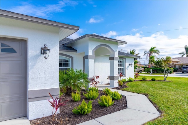 entrance to property featuring a yard