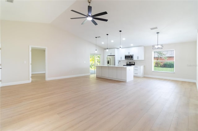 unfurnished living room featuring light hardwood / wood-style floors, high vaulted ceiling, ceiling fan, and sink