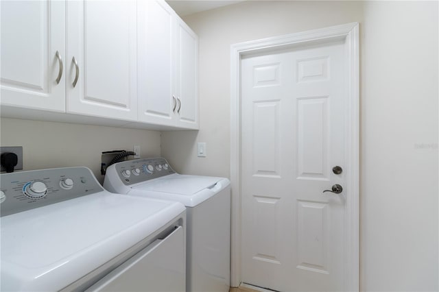 laundry area with cabinets and washing machine and clothes dryer