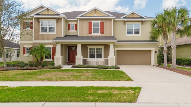 view of front of property featuring a front yard and a garage