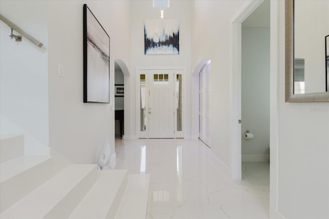 entryway with a towering ceiling