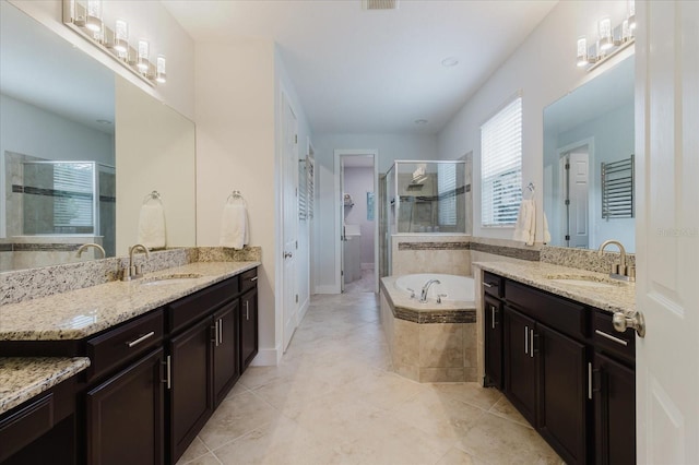 bathroom featuring vanity, independent shower and bath, and tile patterned flooring