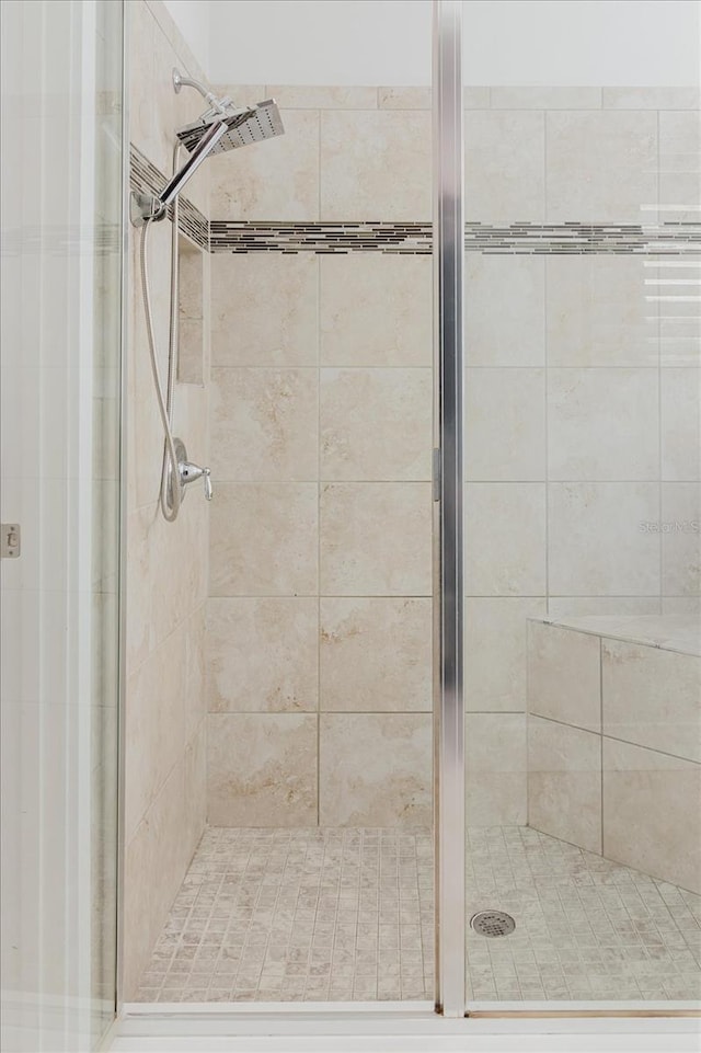 bathroom with a shower with door