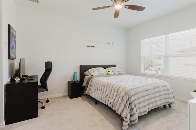 bedroom featuring light colored carpet and ceiling fan