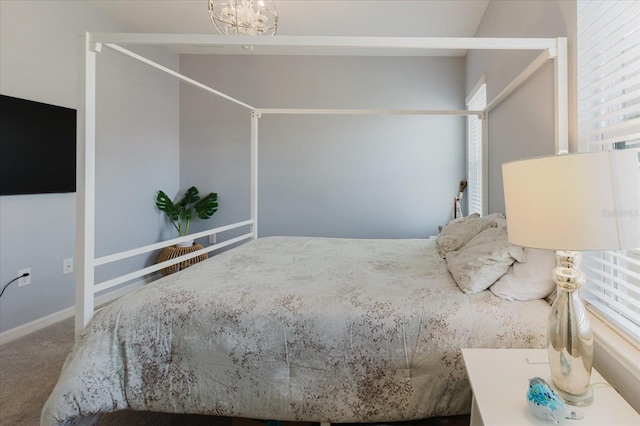 carpeted bedroom featuring an inviting chandelier