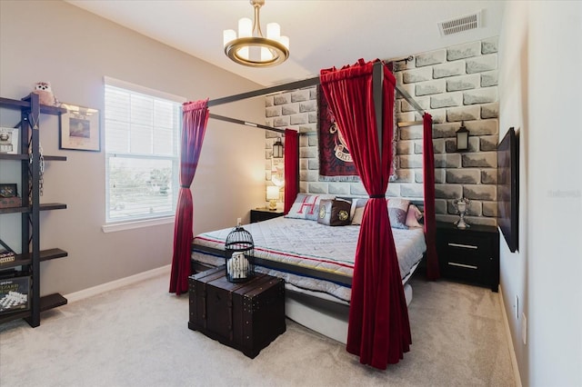 carpeted bedroom with a chandelier