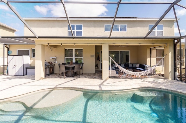 back of house featuring a lanai and a patio area