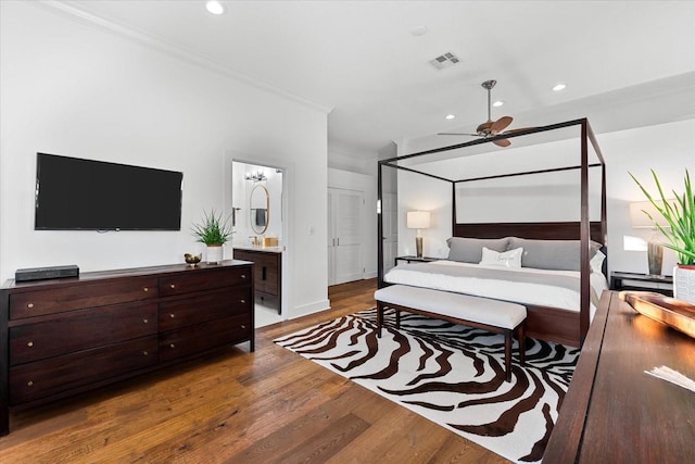 bedroom with recessed lighting, visible vents, wood finished floors, and ornamental molding