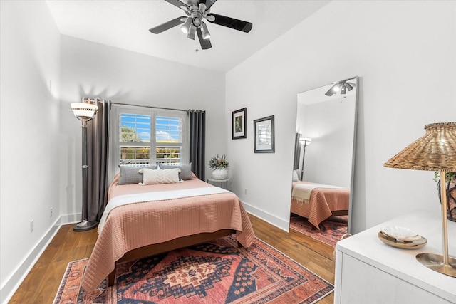 bedroom featuring ceiling fan, baseboards, and wood finished floors