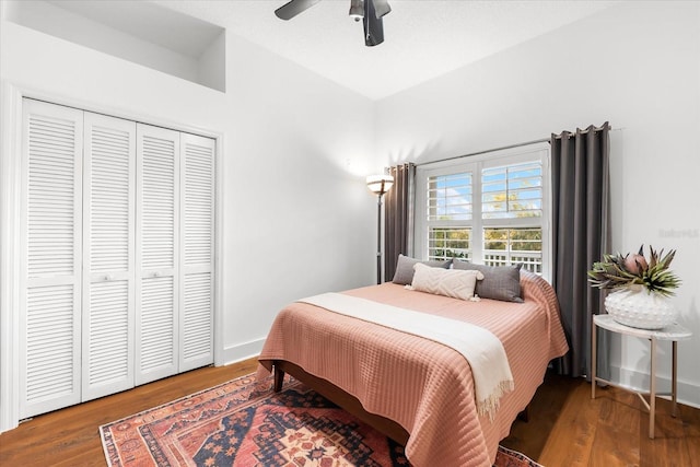 bedroom featuring a closet, baseboards, and wood finished floors