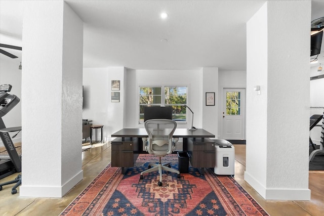 office space featuring ceiling fan, baseboards, and a textured wall