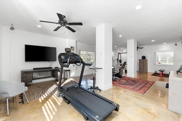 exercise area with recessed lighting, a healthy amount of sunlight, baseboards, and a ceiling fan