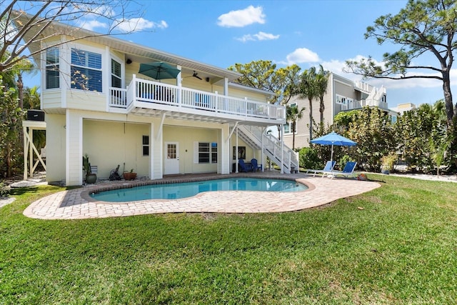 rear view of house featuring a wooden deck, stairs, a lawn, a ceiling fan, and a patio