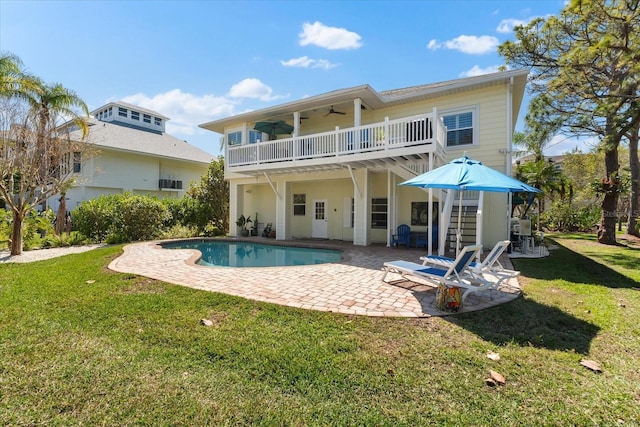 rear view of property featuring a patio area, a yard, stairs, and ceiling fan