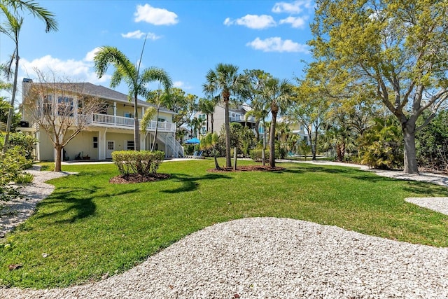 view of home's community featuring stairs and a lawn