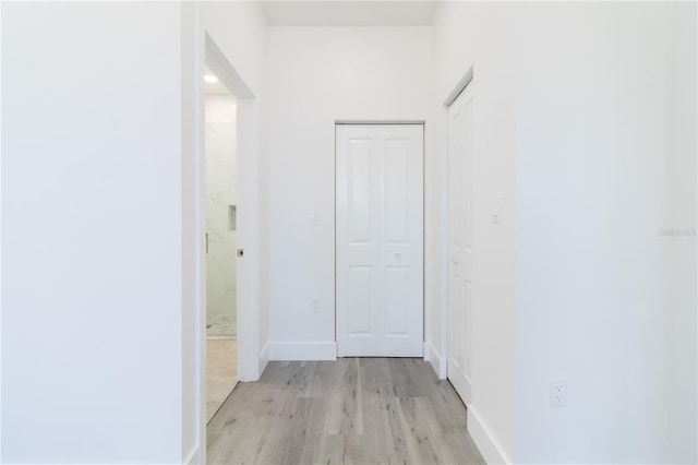 hall with light hardwood / wood-style floors