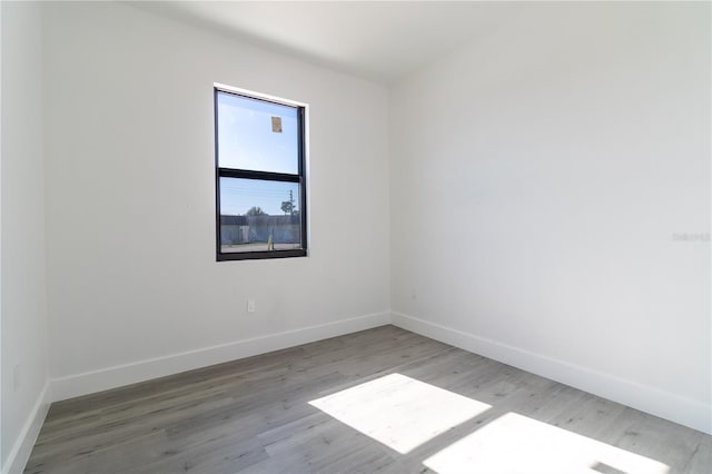 spare room with wood-type flooring