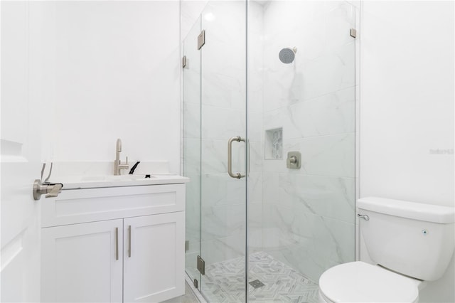 bathroom featuring vanity, toilet, and walk in shower