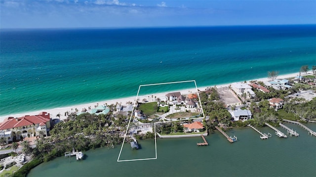 birds eye view of property with a view of the beach, a residential view, and a water view