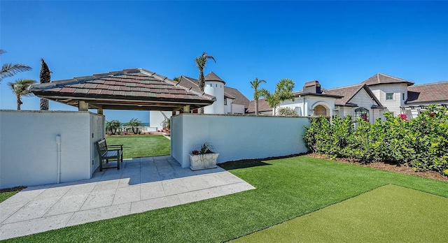 view of yard featuring a gazebo, fence, and a patio