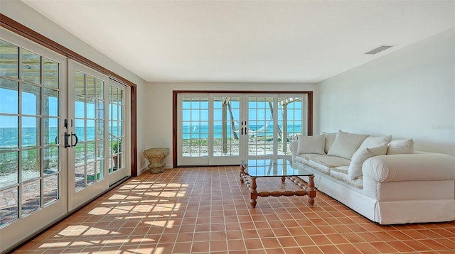 tiled living area featuring french doors and visible vents