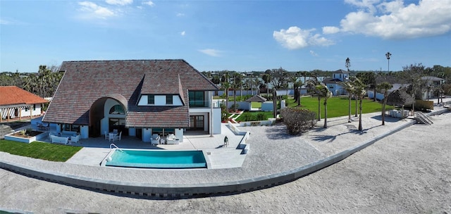 view of home's community featuring a patio, a swimming pool, and a lawn