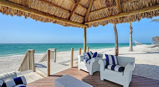 dock area featuring a gazebo, a beach view, and a water view