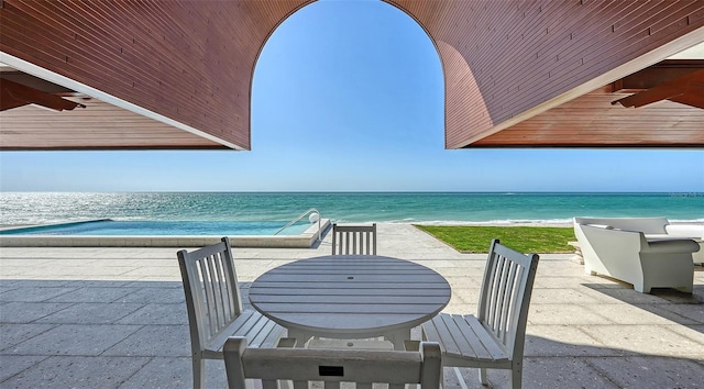 view of patio featuring a water view and outdoor dining space