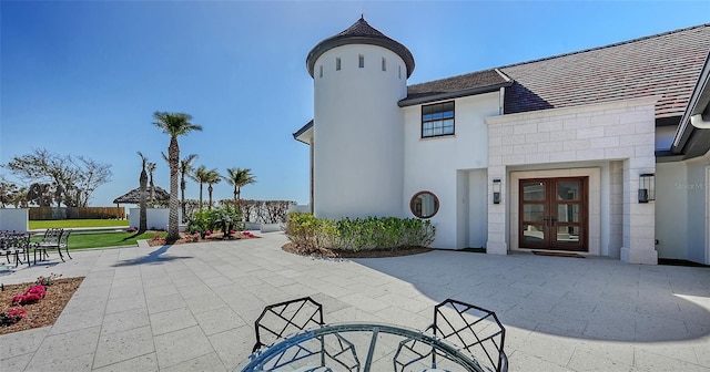 exterior space featuring stucco siding, a patio, and french doors