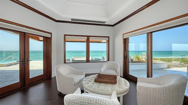 sunroom / solarium with french doors and a water view