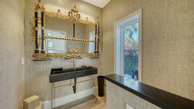 bathroom with a sink and wood finished floors