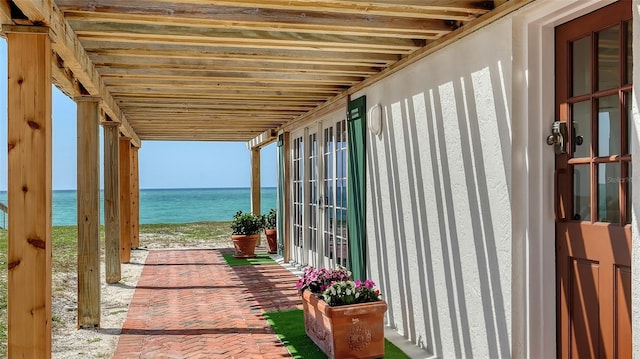 exterior space featuring a water view and french doors