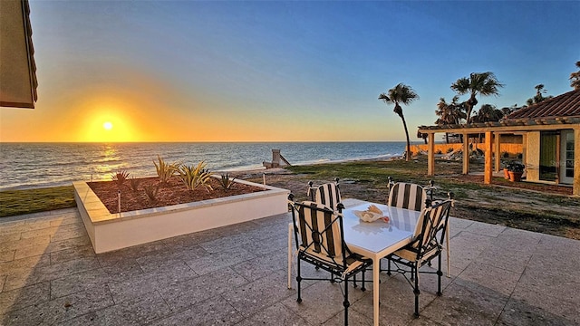 view of patio / terrace with outdoor dining area and a water view