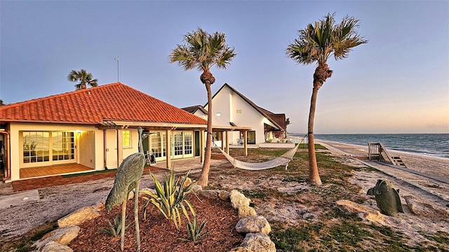 exterior space with a water view and a patio